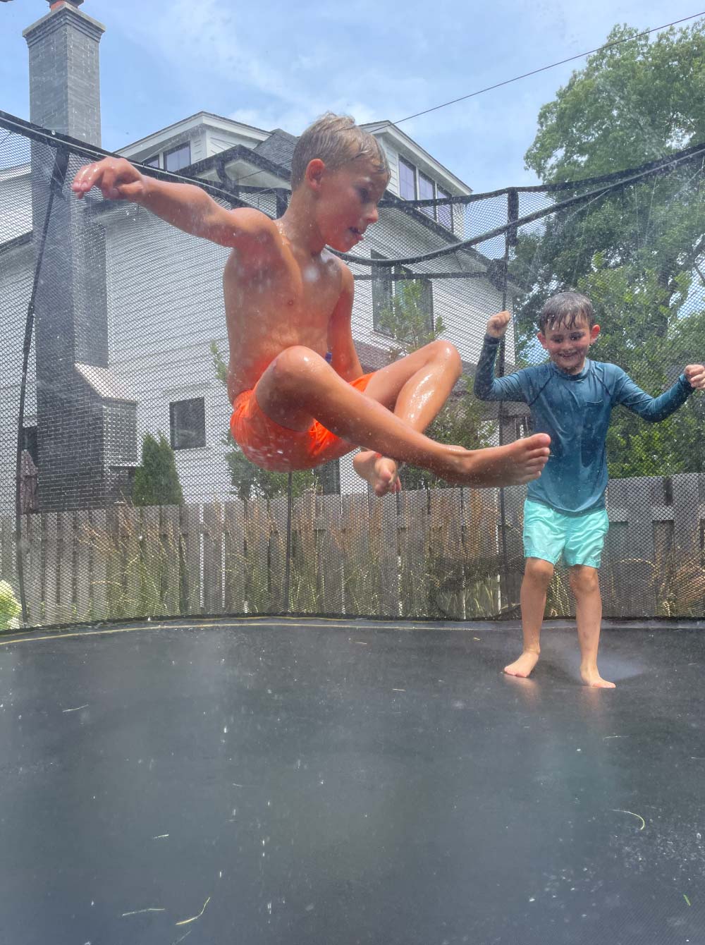 boys jumping on trampoline